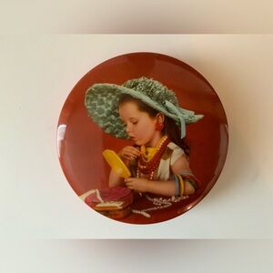 Vintage Round Tin Featuring Girl in Teal Hat and Red Background